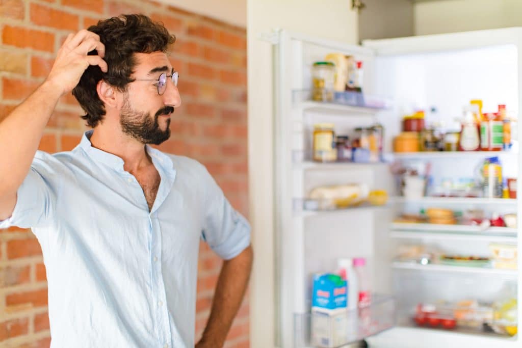 man in front of refrigerator