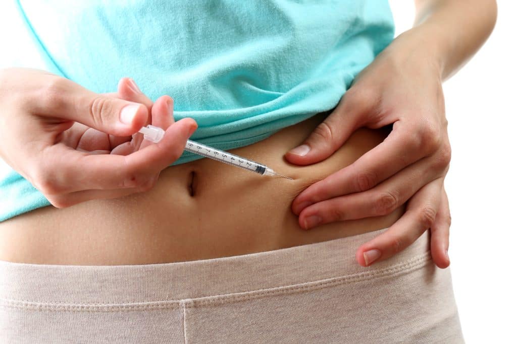 woman stomach injection