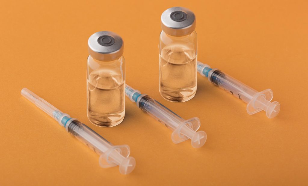 multiple syringes on orange