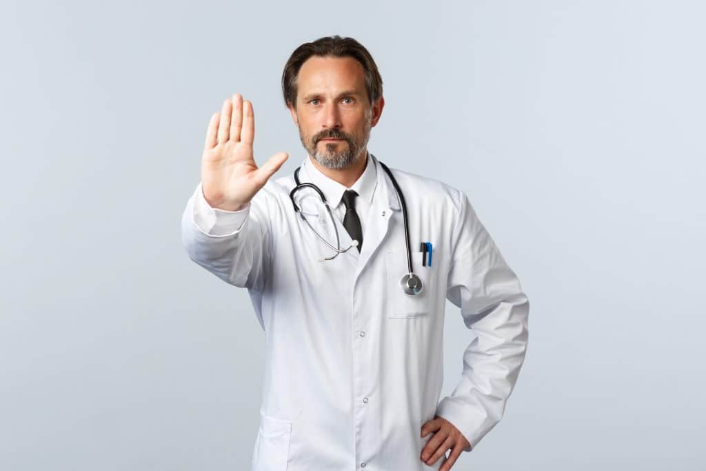 doctor holding up hand