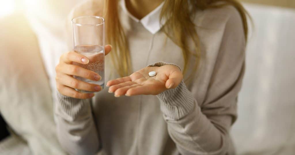 woman holding supplements